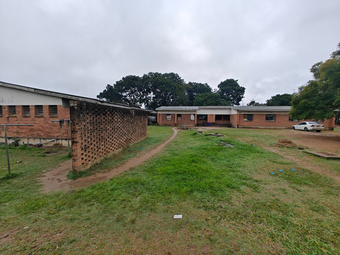 Mwanza Primary Health Care Unit exterior with people