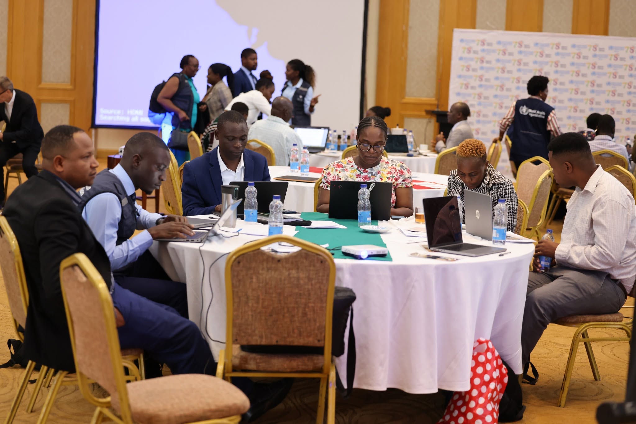 Working groups at the BICC workshop reviewing and entering data