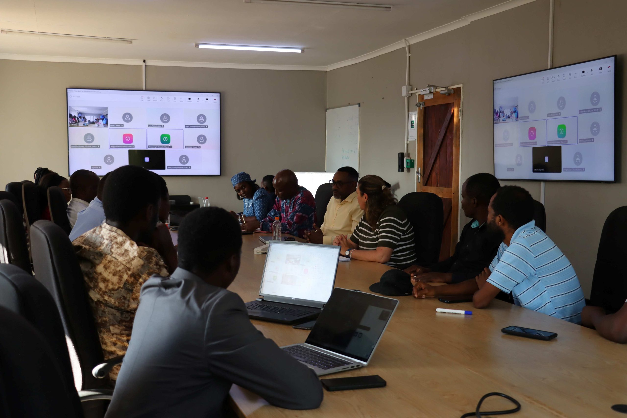 SADCAS Assessors and PHIM Scientists discussing technical genomics procedures